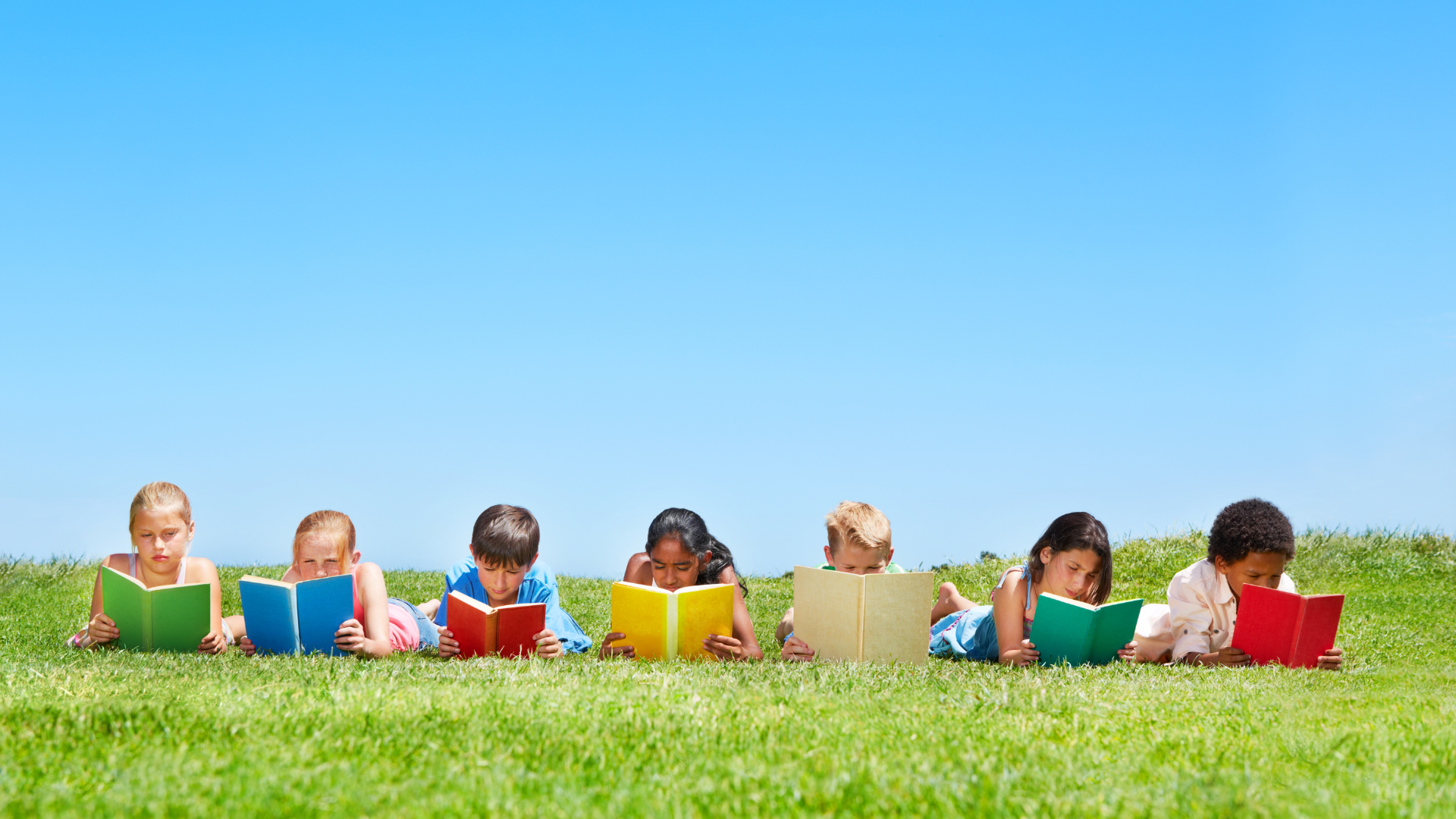 A child enjoying summer reading with different options like audiobooks, graphic novels, or traditional books to develop a love of reading.